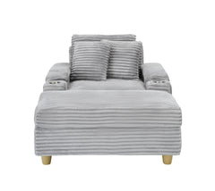Grey corduroy single sofa with one pillow, two throw pillows, a footstool and two storage Spaces.